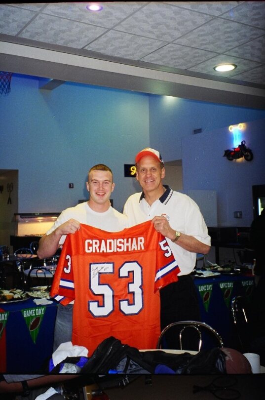 Randy Gradishar with military personal with signed bronco jersey 